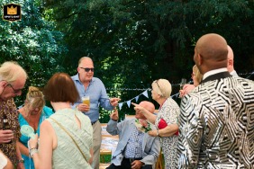 Wedding guests accuse each other playfully at Castle Acre in Kings Lynn, Norfolk, turning the reception into a lively game and laughter-filled exchange of challenges.